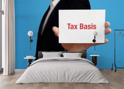 Tax Basis. Business man in a suit holds card at camera. The term Tax Basis is in the sign. Symbol for business, finance, statistics, analysis, economy Wall mural