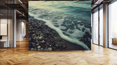 120. A deserted shoreline with smooth pebbles and gentle waves Wall mural