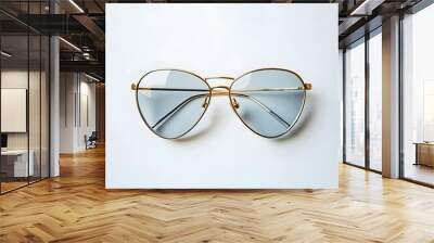 32. A pair of stylish sunglasses with gold frames isolated on a clean white background Wall mural