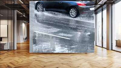 blue car splashes on flooded road Wall mural