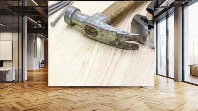 hammer, nails and pincers on wooden board background Wall mural