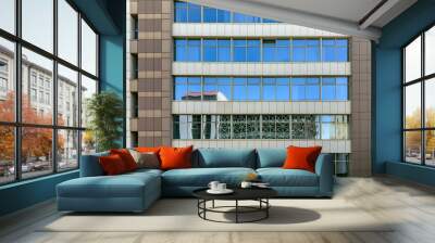 modern office building facade. windows reflecting the blue sky and surrounding buildings Wall mural