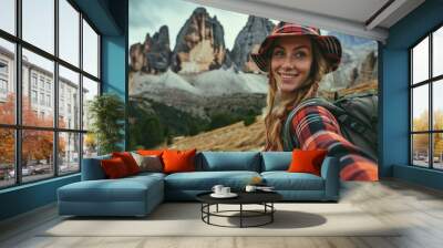 Alpine Adventure: In the Italian Alps, a smiling native woman with a backpack takes a selfie near the Dolomites, portraying the joy and cultural essence of her travel adventure.

 Wall mural