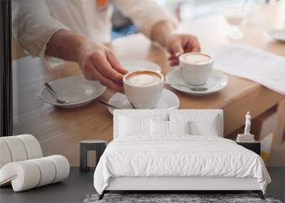 Barista serves two cups of fresh cappuccino in a cafe in the morning Wall mural