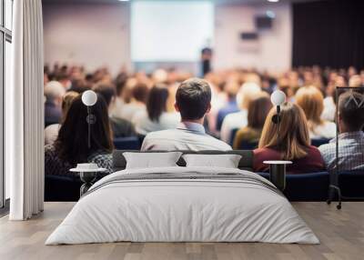 Business people or students are watching a presentation or attend a training or seminar in a lecture hall or auditorium. Conference hall full of people participating in the business training Wall mural