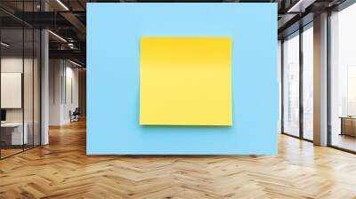 Yellow sticky note on blue background. Top view with copy space. Wall mural