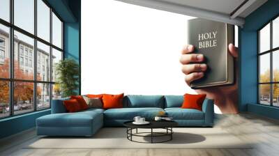 Hand holding the holy bible. Isolated transparent PNG background. Salvation through the holy scriptures concept. With copy space. Faith, Salvation, Peace, Prophecy, Grace. Wall mural