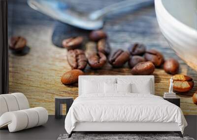 Coffee beans on woood table with cup and spoon Wall mural