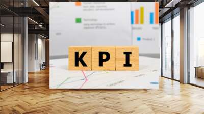 Three wooden blocks with the word KPI on a graph sheet. Abbreviation for Key Performance Indicator, growth business and investment. Business and financial market concept. Wall mural