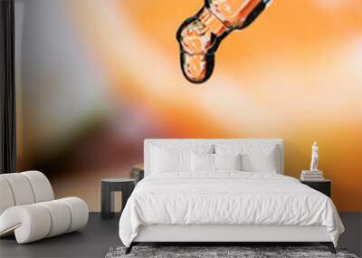 Drop of oil on a background of citruses. Cosmetic pipette with essence. Wall mural