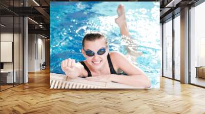 Woman in black goggles in swimming pool Wall mural