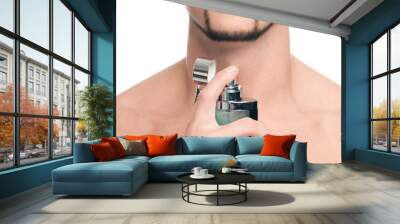 Young handsome man applying perfume Wall mural