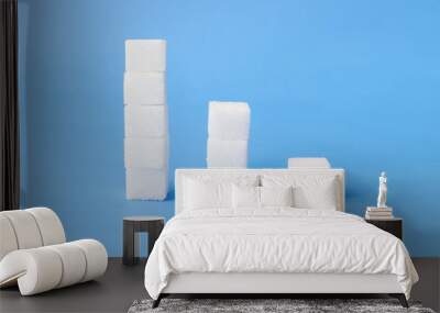 High to low stacks of sugar cubes with blue background, health care concept Wall mural