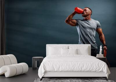 Nutritional Supplement. Muscular Men Drinks Protein, Energy Drink After Workout Wall mural