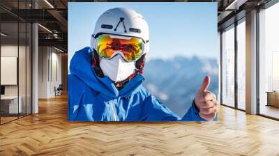 Portrait of a male skier wearing a FFP2 mask Wall mural