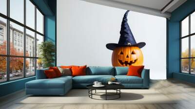 A Carved Pumpkin Wearing a Witch's Hat on a White Background Wall mural