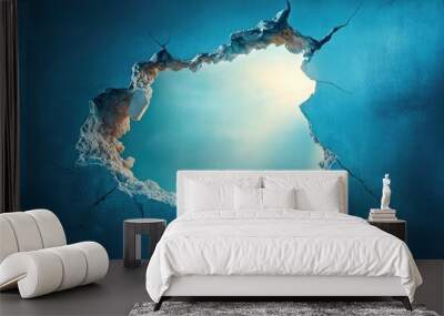 A Crack in a Blue Wall Revealing a Bright Sky Wall mural