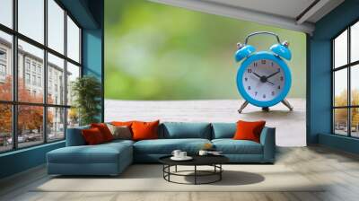 Retro pastel blue alarm clock in outdoor environment Wall mural