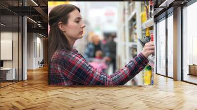 woman buys spice in supermarket or store. Wall mural