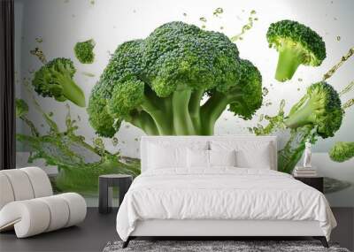 Fresh Broccoli a few slices and a splash of Fresh Broccoli juice form a dynamic image against a white background Wall mural