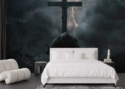 A christian warrior, crusader knight is kneeling in front of a cross with a sword in his hand. The sky is dark and stormy, and there are many rocks in the background. Scene is ominous and foreboding Wall mural