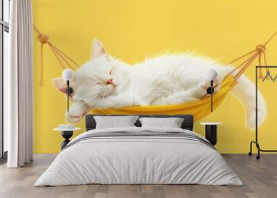 Adorable white cat, kitten sleeping in a hammock against vibrant yellow background. Wall mural