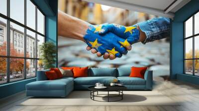 Two people shaking hands with the hands painted in blue and yellow. The blue and yellow paint symbolizes the European Union. Handshake with EU Flag Painted Hands. Symbol of Unity and Cooperation. Wall mural