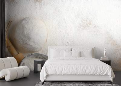 table strewn with flour with a dough roll and a sieve Wall mural