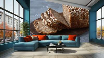 Sliced rye bread on cutting board. Whole grain rye bread with seeds. Wall mural