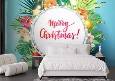 Christmas on the summer beach design with monstera palm leaves, hibiscus flowers, xmas balls and gold glowing stars, vector illustration. Wall mural