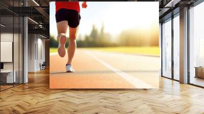 Person running on track during sunset in summer Wall mural