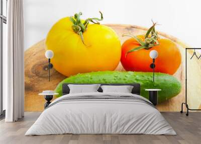 two tomatoes and cucumber on wooden cutting board Wall mural