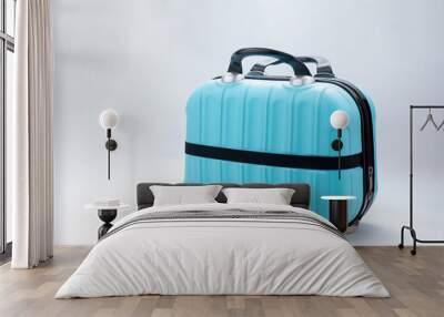 Small blue travel bag with handle, large cloth baggage case. Modern suitcases for traveling. Luggage isolated on white background with copy space. Travel summer holidays, tourism, vacation concept Wall mural