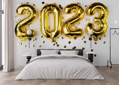 golden foil balloon 2023 New Year. Numbers two thousand twenty three from a foil figure on a gray cement background. Golden confetti and celebration. Wall mural