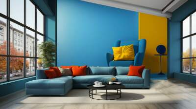 Interior room with a blue armchair and yellow pillow with copy space on blue and yellow wall background. Wall mural