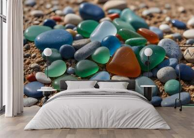 Colorful gemstones on a beach. Polish textured sea glass and stones on the seashore. Green, blue shiny glass with multi-colored sea pebbles close-up. Beach summer background. Wall mural