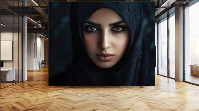 Close-up portrait of a Muslim woman with beautiful eyes in a hijab on a dark background. A girl in a black headscarf is looking at the camera. with generative ai Wall mural