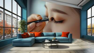 makeup artist using makeup brush for eyes and applying brown eyeshadow. make-up for young asian girl. Close-up with generative ai Wall mural