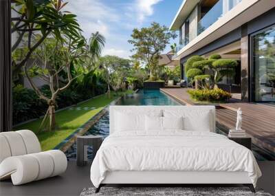 : A chic modern villa with a sleek, rectangular swimming pool, bordered by a wooden deck and lush, manicured gardens, captured in high definition. Wall mural