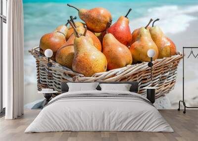 A basket full of pears on a beautiful beach background. Wall mural