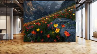 A high mountain pass with glowing neon red and yellow alpine flowers dotting the landscape, offering a stark contrast to the rugged terrain. Wall mural