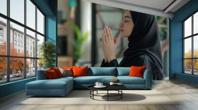 beautiful young muslim lady in scarf performing namaz prayer making dua Wall mural