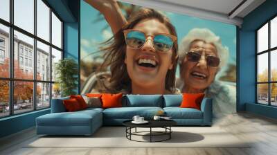 young lady and old lady enjoying, partying together, grand daughter and grandmother having summer vacation at beach, water park Wall mural