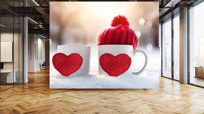 Love at coffe time, christmas concept, mug and red heart decoration on a snow balcony. Cup with heart and a hot drink wrapped in a scarf in the snow. Valentine's day concept Wall mural