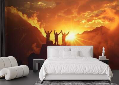 silhouette of a persons jumping on top of mountain at sunset Wall mural