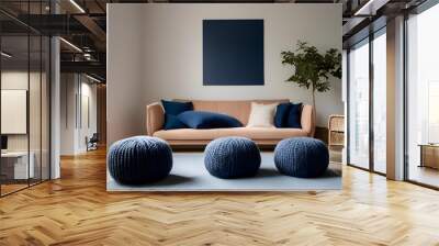 Two knitted poufs near dark blue corner sofa. Scandinavian home interior design of modern living room . Wall mural