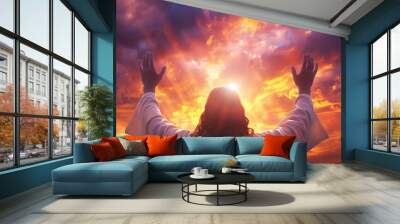 Rear back view of Jesus Christ raised hands and praying to god with a sunrise sky background Wall mural