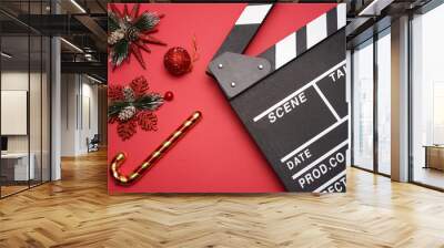 Filmmaker clapperboard with christmas decorations on red background. A Christmas movies and holiday classic cinema and TV flicks conceptual Wall mural