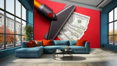 vacuum cleaner nozzle sucking money dollar bill on red background Wall mural