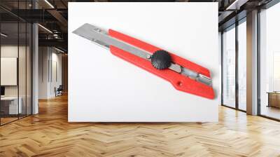 Red utility knife cutter isolated on white background. Stationery cutter knife Wall mural